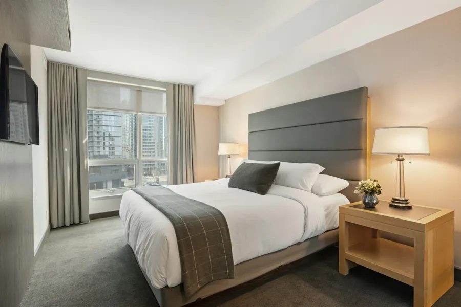 Hotel-style guest bedroom with crisp white bedding, ready for the next guest