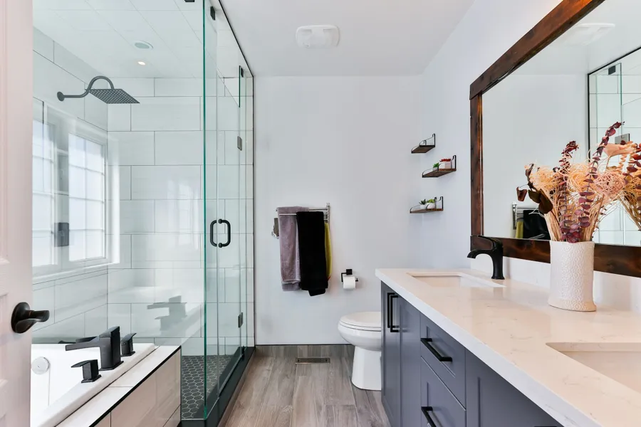 Sparkling bathroom with glass shower, vanity and mirror